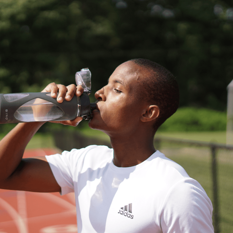 _A man drinking water from a tumbler A man drinking water from a tumbler.