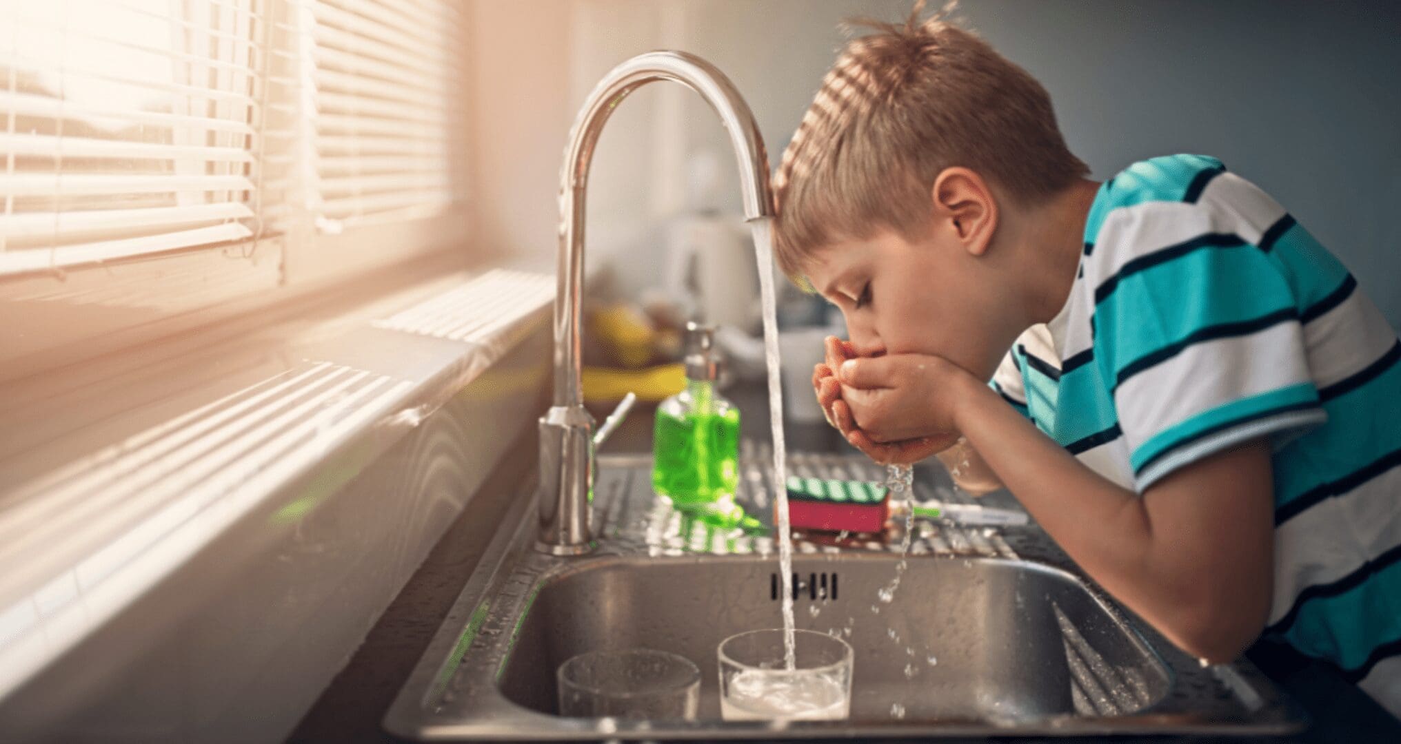 _child drinks from unfiltered tap water child drinks from unfiltered tap water