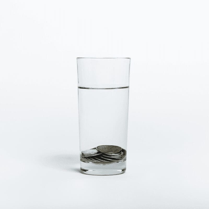 Coins inside a glass of water. Coins inside a glass of water.