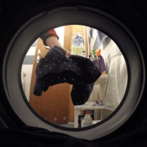 throwing laundry in the washer