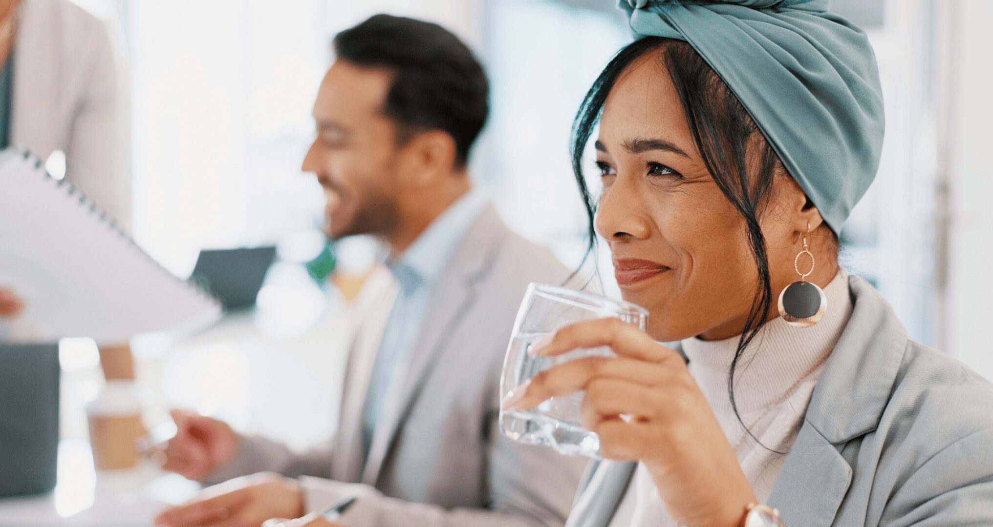5 Ways a Bottleless Water Cooler Benefits Your Texas Business smiling woman drinking water at the office