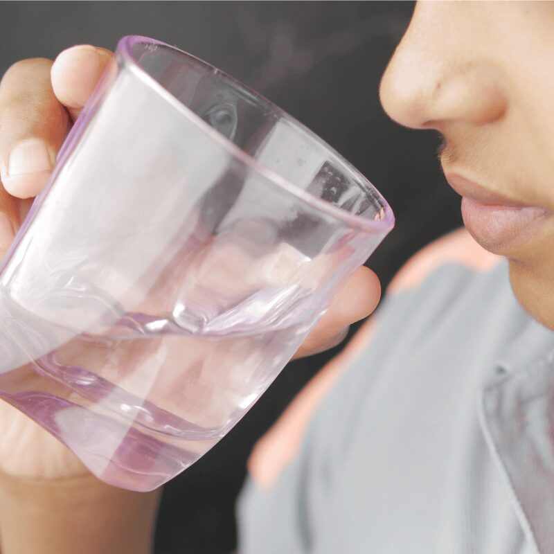 teenage boy drinking water up close
