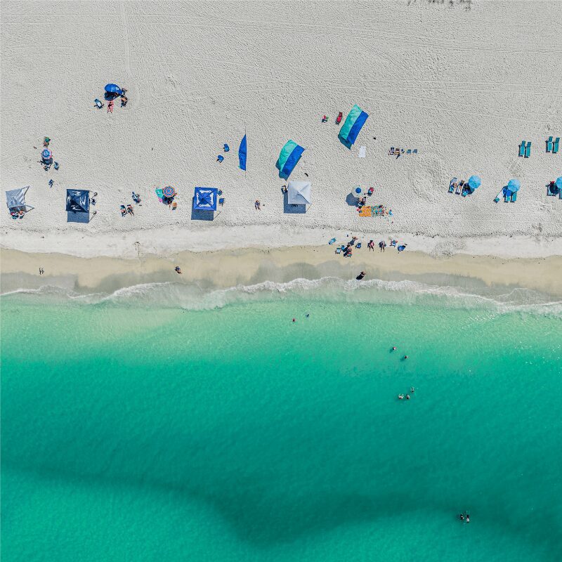 aerial-view-of-holmes-beach-on-anna-maria-island areal shot of beach goers