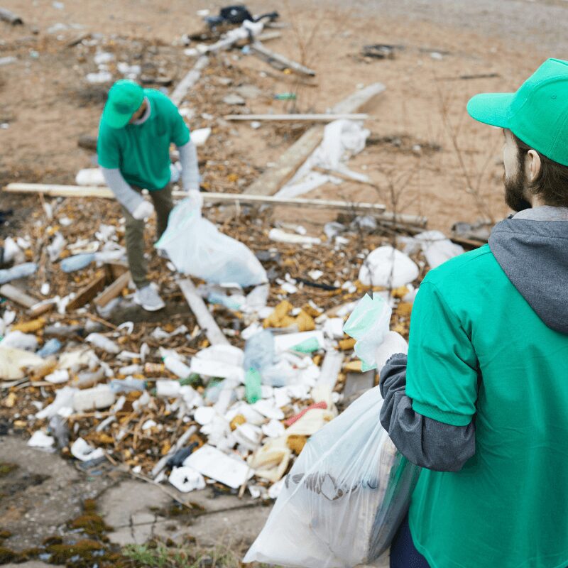 Volunteers picking up trash Volunteers picking up trash along river bank