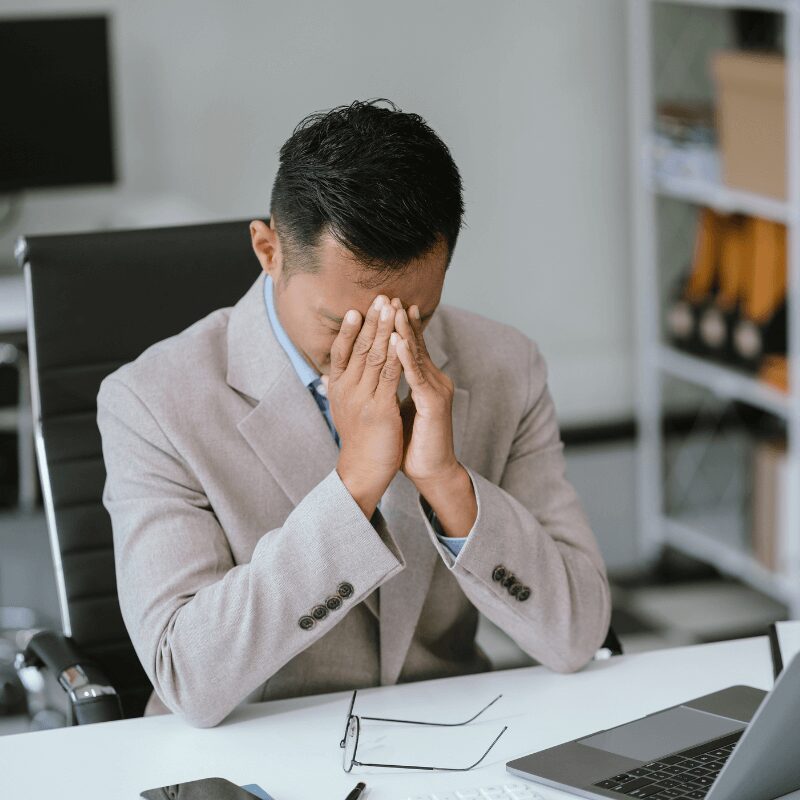 stressed-businessman-calculating-bills-and-taxes business man not feeling well at work