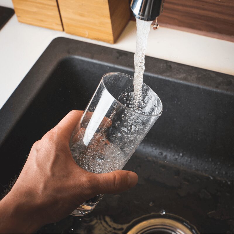 filling a glass of water at the sink filling a glass of water at the sink