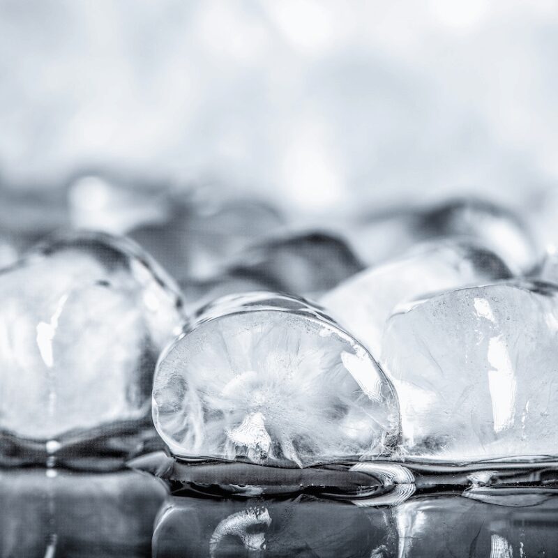 ice-cubes-on-a-black-background up-close view of melting ice cubes