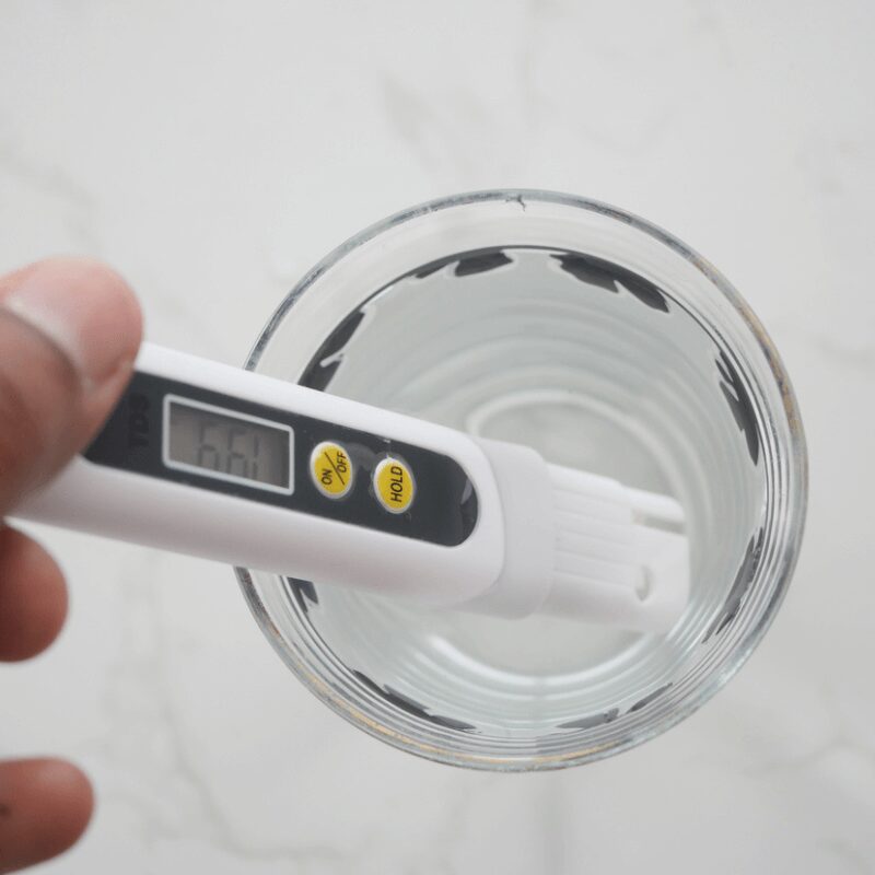 water text meter sitting in a glass of water