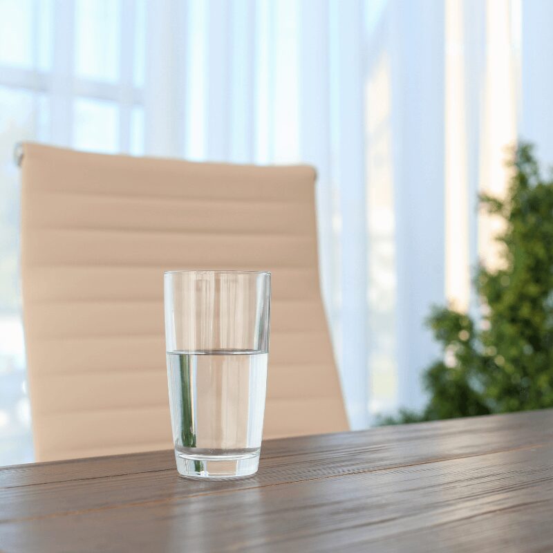 glass of water on the table in an office