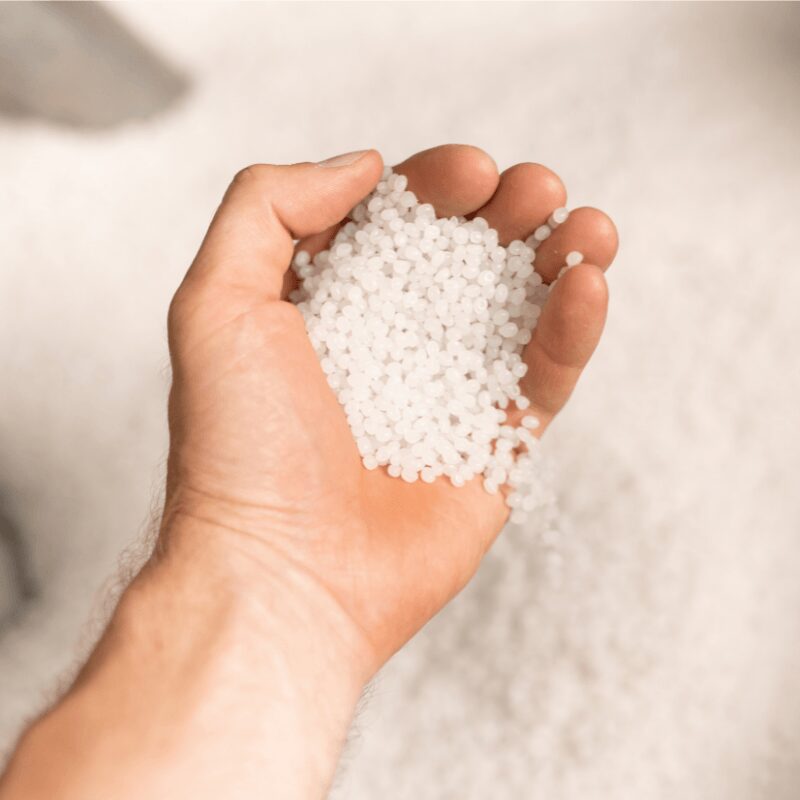 hand of a young man holding water softener salt