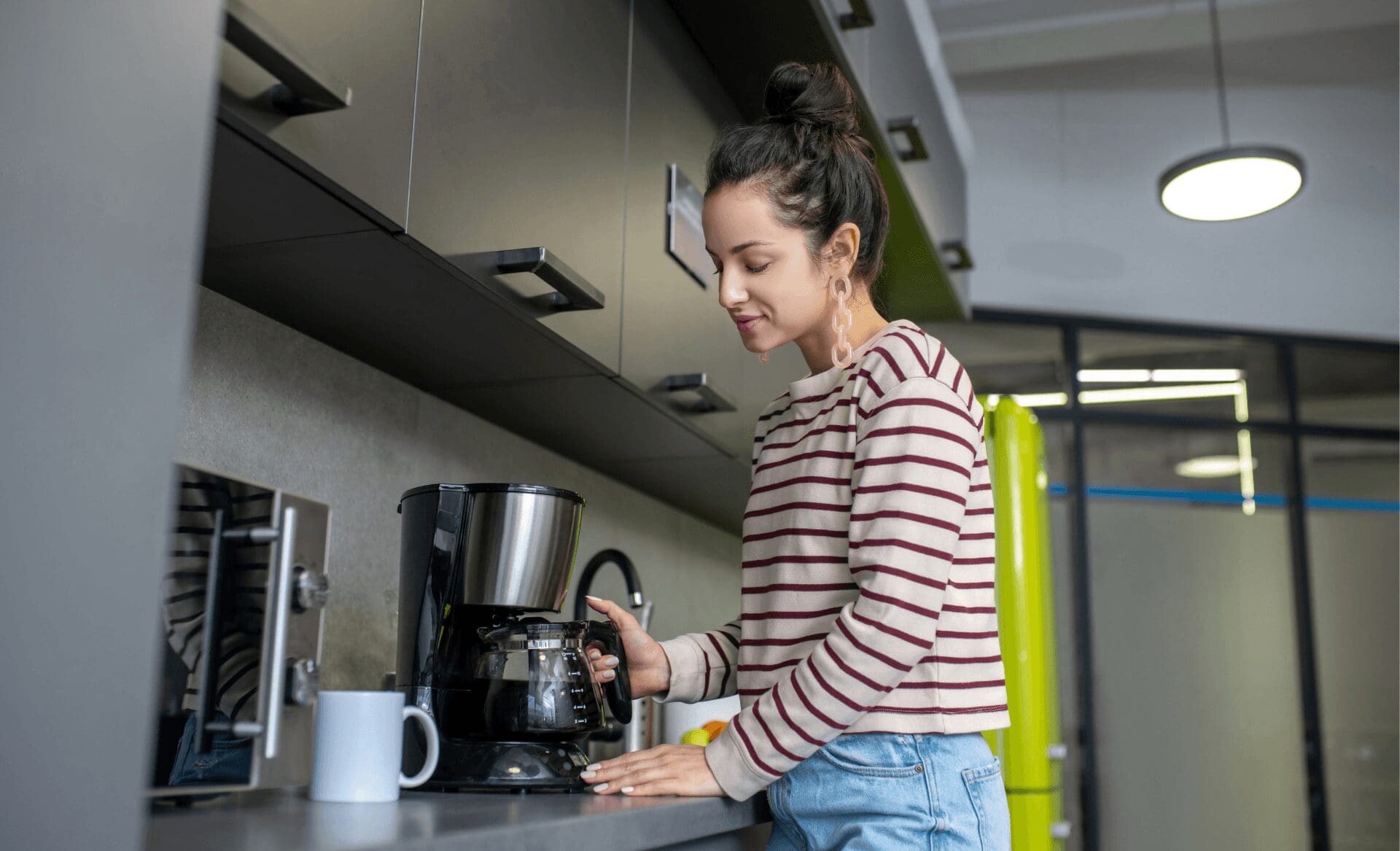 female employee making coffee at the office