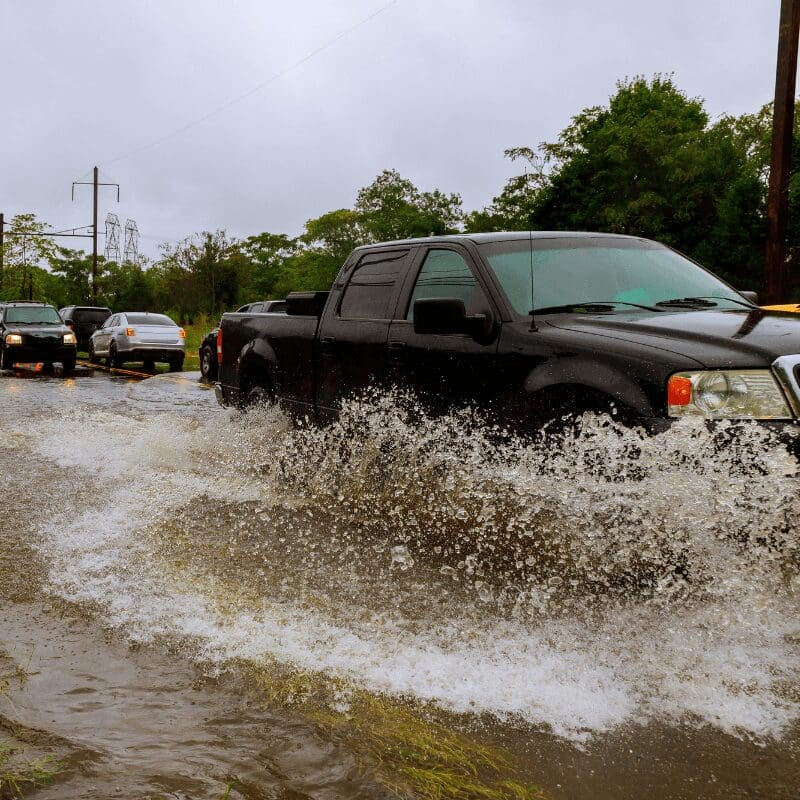 flooded-feeder-street Truck driving through flooded street after a hurricane