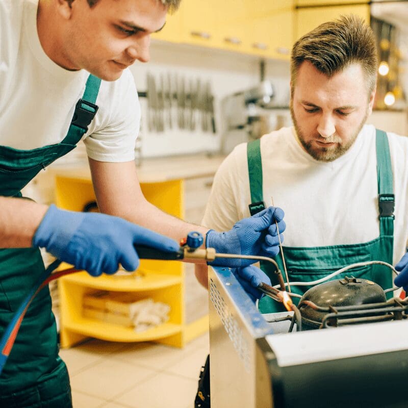 repair men fixing a commercial coffee machine