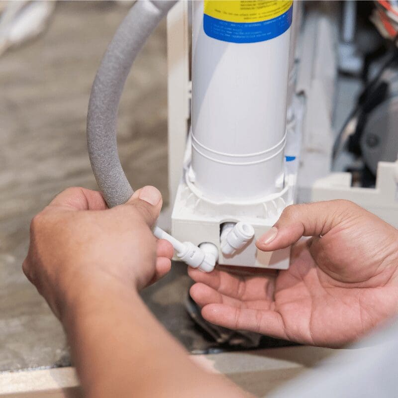 plumber-connecting-tubing-to-a-water-filtration-system plumber connecting tubing for a water filtration system